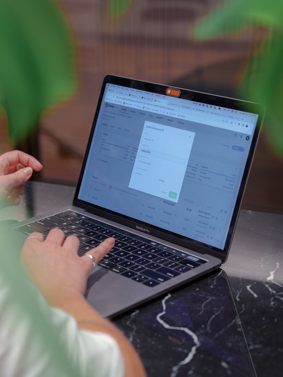 Person managing a project budget on a laptop